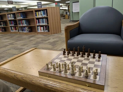 chess board on table with chair in library