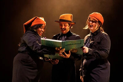 3 characters in hats holding books