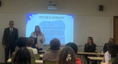 students in classroom with voter eligibility on screen