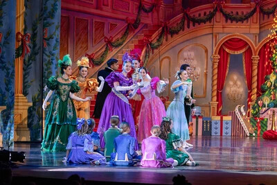 dancers standing and sitting on stage in nutcracker
