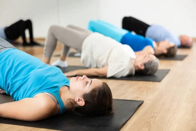 people doing back stretches on mat