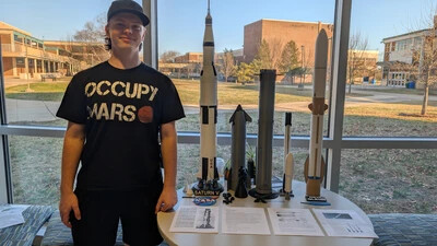 student with model rockets