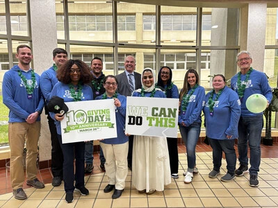 giving day photo outside atrium with staff