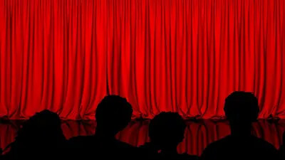 Audience in front of a theatre curtain