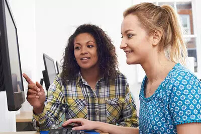business women giving computer training