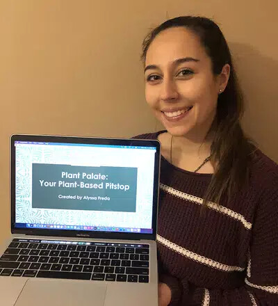alyssa freda holding laptop with presentation