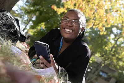 smiling girl outside with fall colors