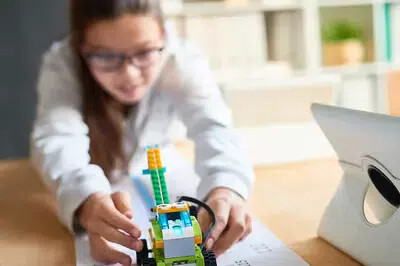 girl with robot using lego