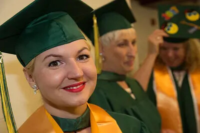 older female grad facing camera