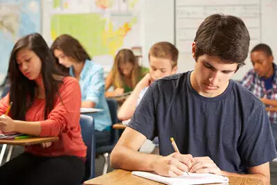 class of students taking a test