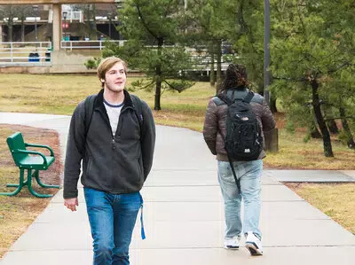 front and back of male students walking outside