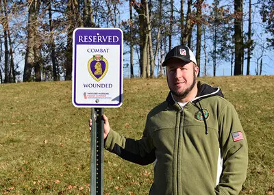 Justin Macarone in front of veteran parking sign