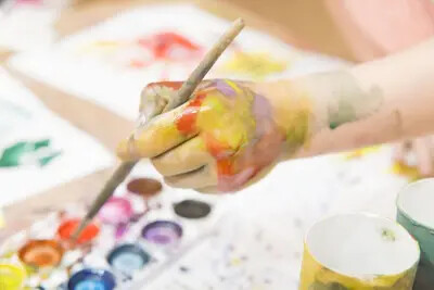 child's hand painting watercolor