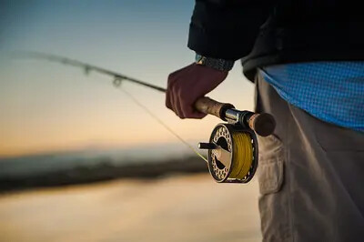 man holding fly fishing pole