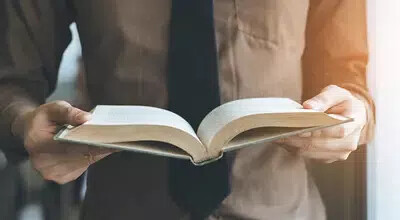 man holding open book