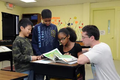 3 children with rvcc male student tutoring them