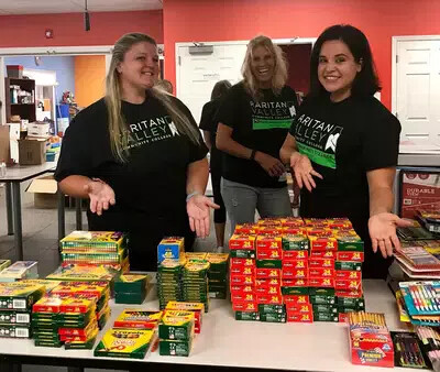 3 female ota students sorting school supplies