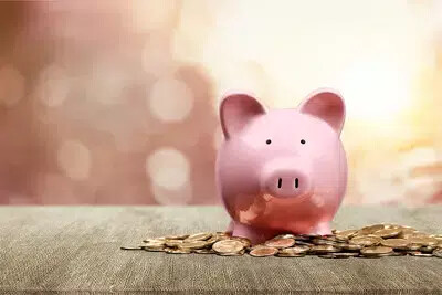 pink piggy bank with coins