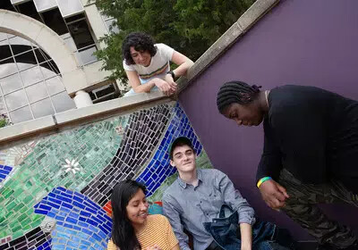3 students near theatre arch