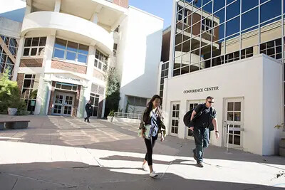 people walking outside college entrance