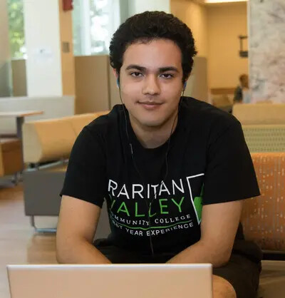 student at laptop cropped at bottom