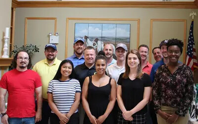 students with WB Mason execs at golf classic