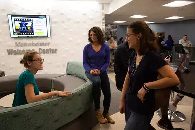 3 female students at welcome center