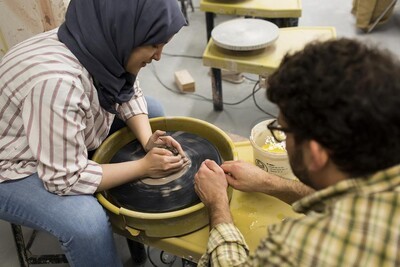 moore college student on pottery wheel