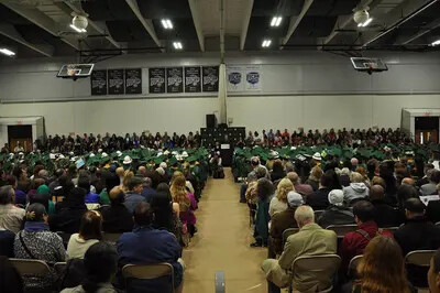 grads and audience in gym