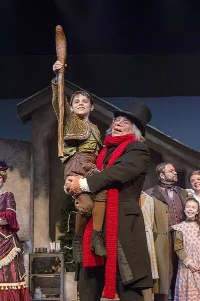 man holding child with crutch in air