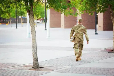 soldier with books outside
