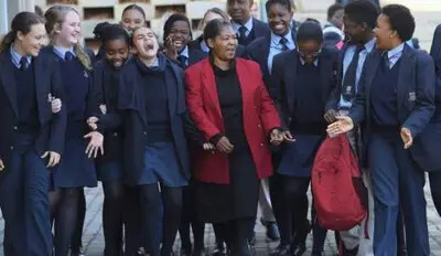 woman with students in school uniforms