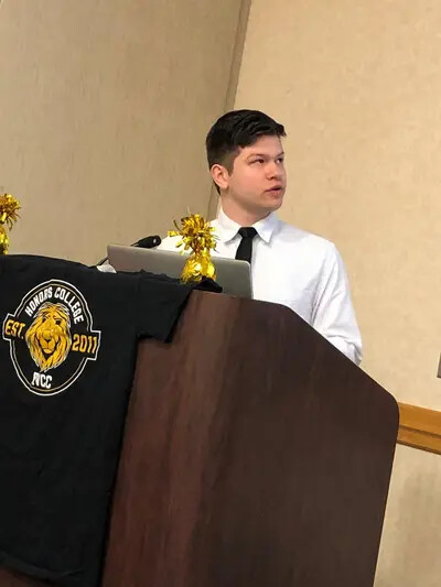 capstone male student at podium