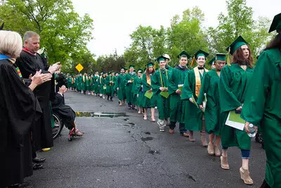 faculty applauding line of grads