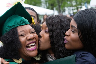 family kissing female grad