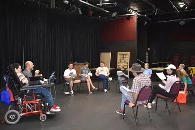 semi-circle of students and dennis russo