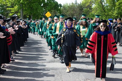 commencement marching grads and applauding faculty
