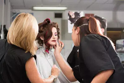 student working on student model's makup
