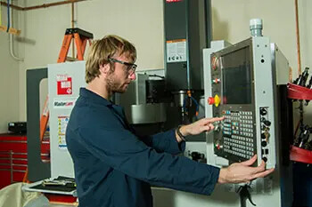 male student working on machine