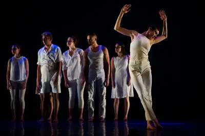 group of dancers dressed in white