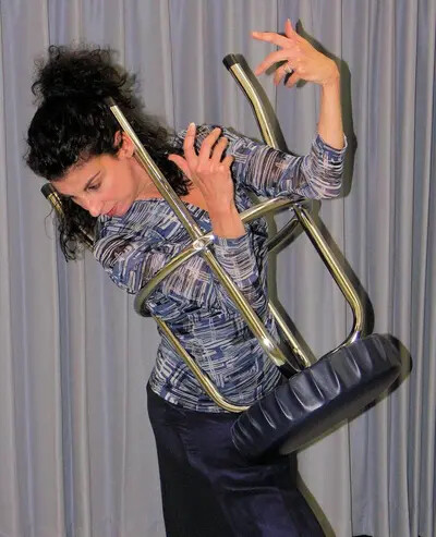 Loretta Fois performing with chair