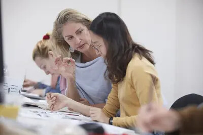female teacher working with female student 