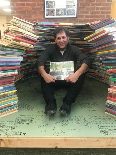 author with stacks of books