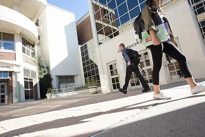people walking at front of college