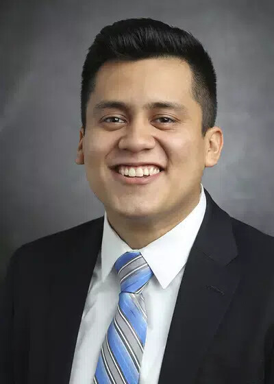joel reyes-guzman wearing jacket and tie