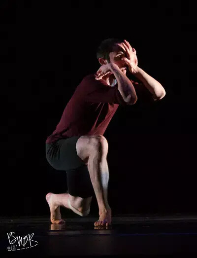 nathan forster kneeling in performance