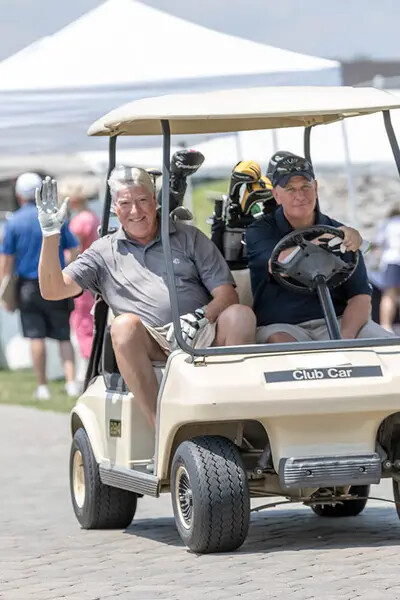 two golfers in golf cart
