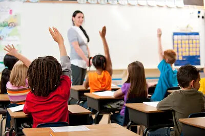students raising hands