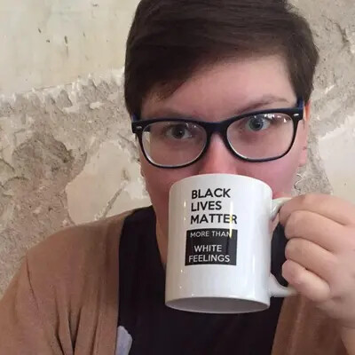 theodra band drinking from mug