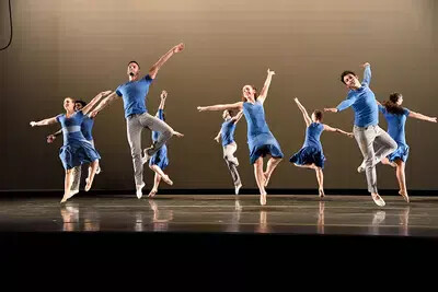 male and female dancers dressed in blue